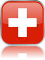 Man sieht im Bild die Flagge der Schweiz auf einen Metallbutton plus Spiegel gestaltet. In der Schweiz gibt es 6 Bach Chöre, Bach Orchester oder Bach Vereine.